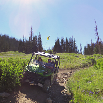 Us riding in side by side one mountain trail